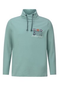 Light green long-sleeve pullover with high collar, adjustable drawstrings, and nautical-themed print featuring flags and text. Soft texture.