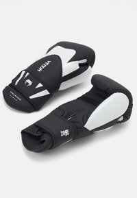 Black and white boxing gloves with padded knuckles, adjustable wrist straps, and a smooth texture. Features logo and model number on surface.