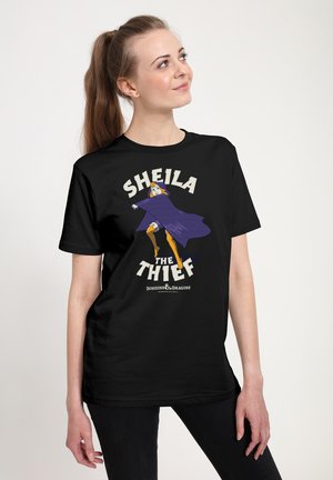 Zwarte t-shirt met een afbeelding van een personage in een paarse mantel en gele laarzen, met de tekst "SHEILA THE THIEF" in vetgedrukte, witte letters.