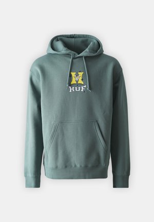 Green cotton hoodie with a kangaroo pocket, featuring a yellow and black logo on the chest with blue stars. Soft texture and relaxed fit.