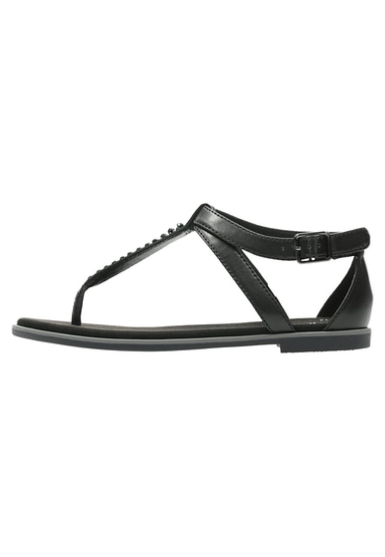 Sandalo in pelle nera con design a T, suola piatta, fibbia regolabile alla caviglia e perline decorative lungo la fascia.
