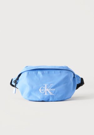 Hele sinine Calvin Kleini vöökott valge logoga, musta reguleeritava rihmaga ja lukuga ühevärvilisel taustal.
