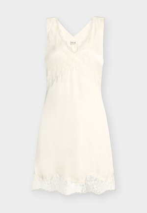 Rochie tip camisă fără mâneci de culoarea fildeșului, cu decolteu în V, dantelă de-a lungul decolteului și tivului, material moale, lungime până la genunchi.