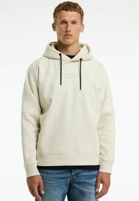 Crèmekleurige hoodie gemaakt van zachte, rekbare stof. Heeft een voorste kangaroeltas, een verstelbare capuchon met koord en een logo op de borst.