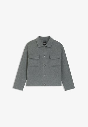 Grau melierte Wollmischungsjacke mit Kragen, Knopfverschluss und zwei Brusttaschen. Verfügt über eine lockere Passform und strukturierte Stoffoberfläche.