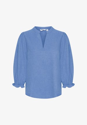 Vaalean sininen pellavapusero, jossa on rento leikkaus, pyöreä kaula-aukko, puolihihat joustimilla ja etupuolella halkio.