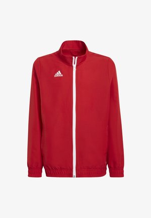 Rode tracksuitjack met hoge kraag, rits aan de voorkant, elastische manchetten en onderkant. Logo aan de linkerkant. Glad stoffen textuur, ontworpen voor actieve kleding.