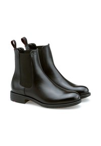 Bottines en cuir noir avec des panneaux élastiques sur les côtés, bout rond et une languette pour un enfilage facile. Semelle texturée pour une bonne adhérence, accents de design minimalistes.