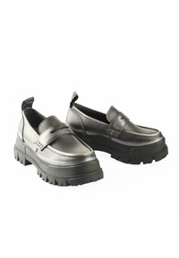 Chunky black loafers made of metallic leather, featuring a thick rubber sole with a tread pattern and a decorative strap across the top.