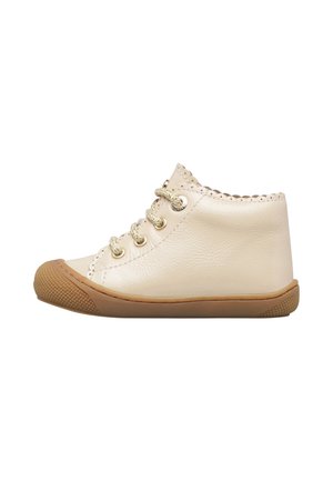 Cream-colored baby shoe with scalloped edges, gold eyelets, matching laces, and a brown rubber sole with textured toe cap.