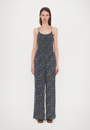 Svart jumpsuit med små blå blomster, tyllstropper, smocket bodice og vide ben. Glatt stoff med en løst fit.