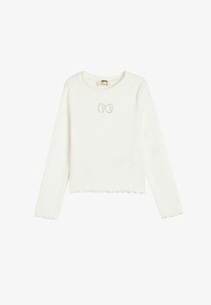 Witte lange mouwen shirt van ribstof, met een gegolfde zoom en een klein decoratief strikje op de borst.