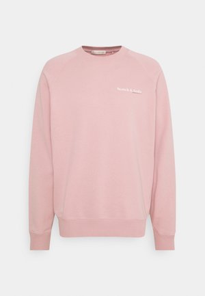 Sweat-shirt rose clair à col rond avec manches longues et logo blanc "Scotch & Soda" sur le côté gauche de la poitrine.
