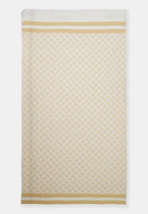 Rechthoekige beige en witte textiel met een herhaald geometrisch patroon en twee parallelle beige strepen nabij beide kortere zijden.