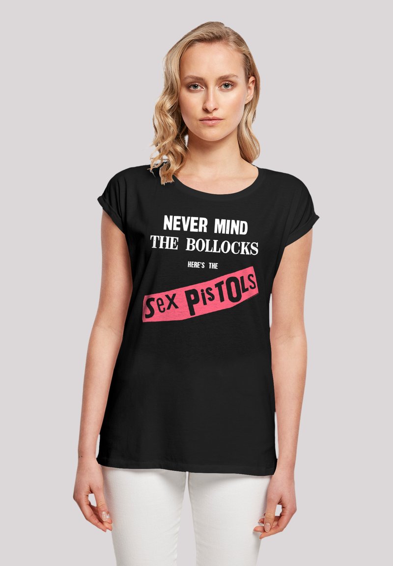 Black short-sleeve t-shirt featuring bold white text "NEVER MIND THE BOLLOCKS HERE'S THE" and a pink banner "Sex Pistols." Smooth cotton fabric.