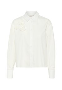 White button-up shirt with a pointed collar, featuring fabric rose accents on the left shoulder and long sleeves, smooth texture.
