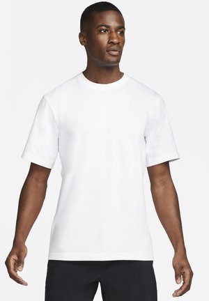 White short-sleeve t-shirt with a round neckline. Made of smooth fabric; features a small, tonal logo on the chest.