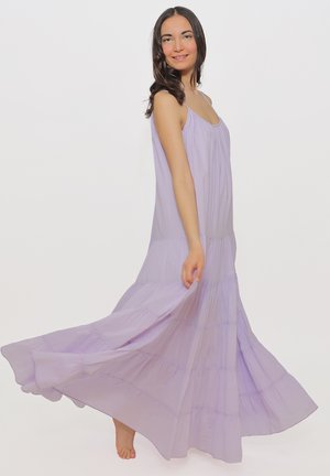 Lavender maxi dress with spaghetti straps, featuring tiered layers and a flowy silhouette. Lightweight fabric enhances movement.