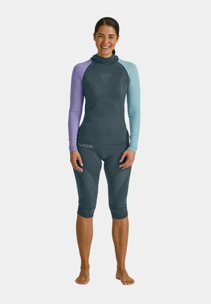 Performance set in dark gray, featuring a long-sleeve top with varying shades of purple and blue sleeves; textured, fitted capri-length bottoms.