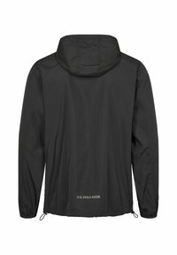 Must kapuutsiga kerge jope elastsete mansettide ja reguleeritava tõmbeniidiga ääres, alumisel seljal kaubamärgiga "U.S. Polo Assn."