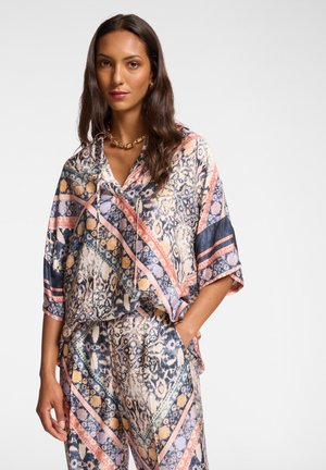 Multicolored silk blouse with a hood, featuring an abstract pattern of blue, pink, and cream. Loose fit with short sleeves.