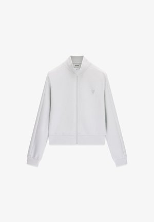 Witte jas met volledige ritssluiting, lange mouwen, opstaande kraag, geribbelde manchetten en een klein logo op de linkerborst van Guess.