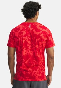 Rotes Kurzarm-Sportshirt aus texturiertem Stoff mit einem Camouflage-Muster und einem gestreiften Akzent am hinteren Halsausschnitt.