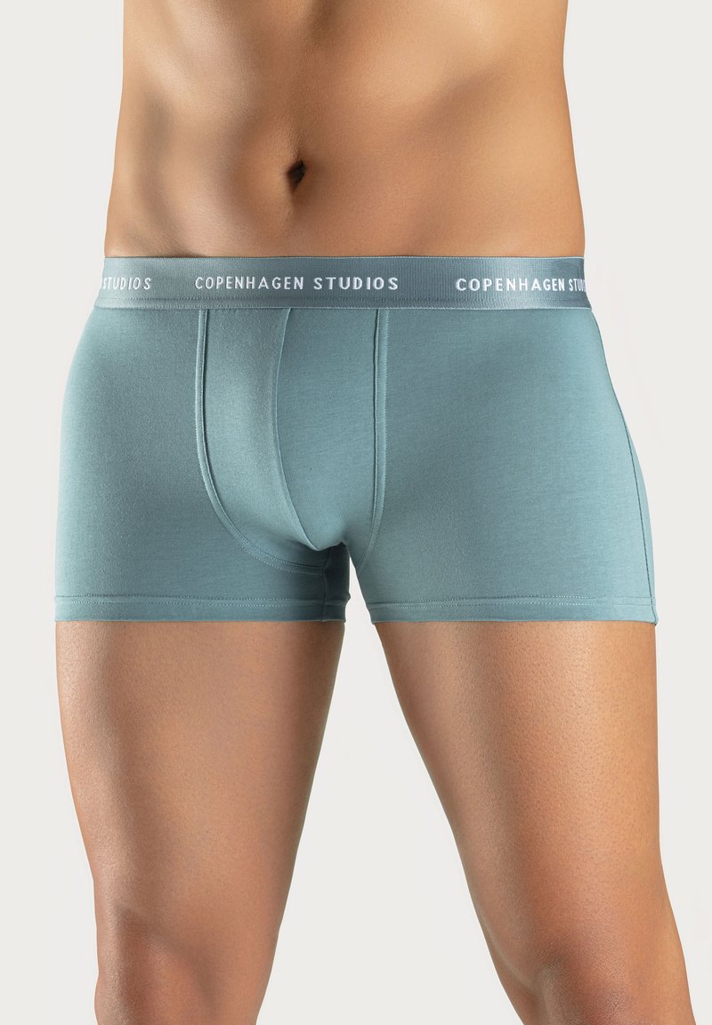 Light blue men's boxer briefs made of soft material, featuring a snug fit and a waistband with "COPENHAGEN STUDIOS" logo in white.