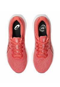 Koraal kleurige sportschoenen met een ademende mesh bovenkant, platte veters, een gevoerde tong en een witte rubberen buitenzool met een zwart logo op de binnenzool.