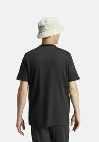 adidas Performance FLD SPW LOGO - T-shirt con stampa - black