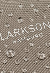 Vodeodolná tkanina vo svetlo sivej farbe s embosovanou textúrou a viacerými okrúhlymi kvapkami. Názov značky "LARKSON HAMBURG" je výrazne zobrazený.