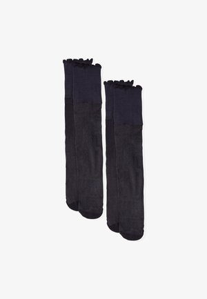 Calze nere fino al ginocchio con una texture morbida, dotate di un bordo superiore arricciato. Realizzate in un materiale leggero, offrono una finitura liscia.
