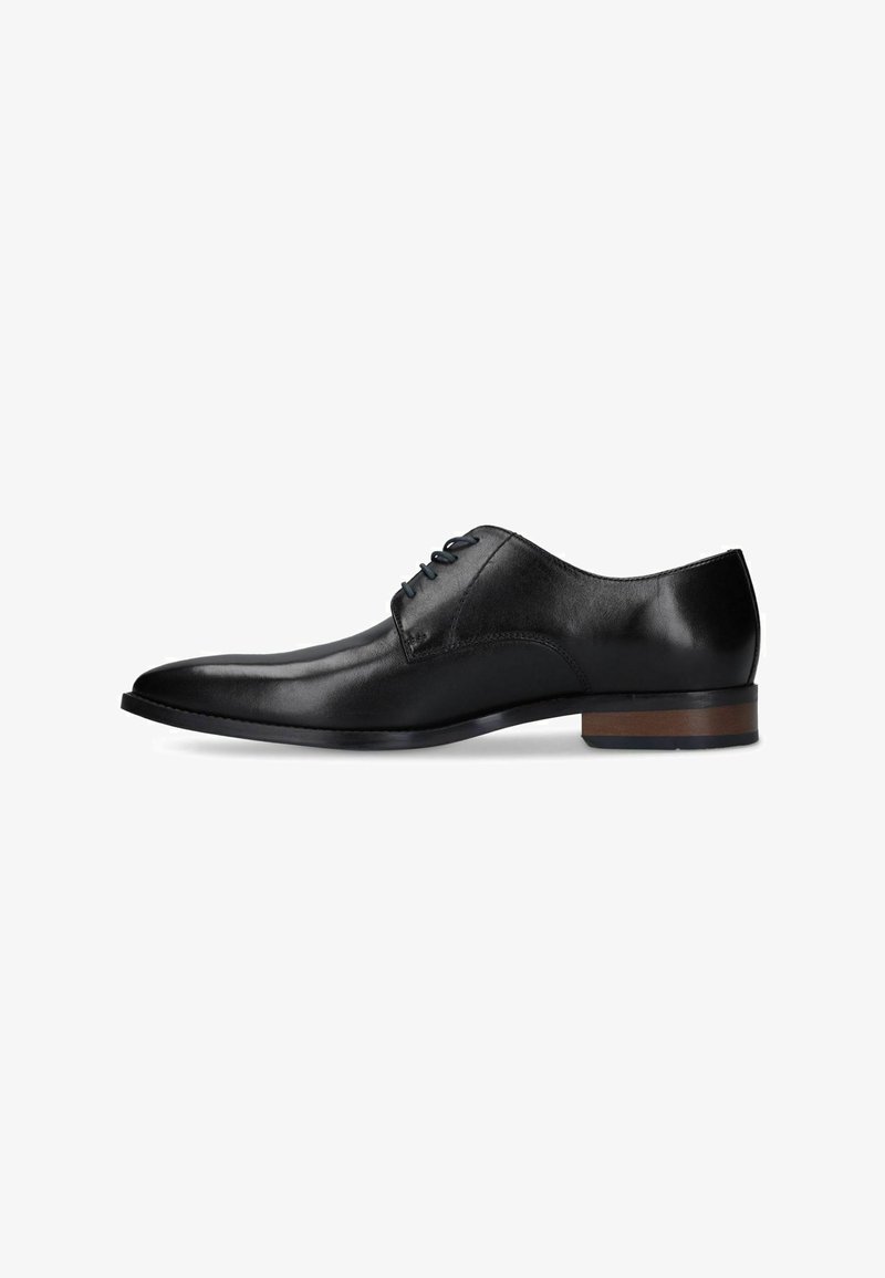 Black leather oxford dress shoe with closed lacing, pointed toe, and low stacked wooden heel on white background.