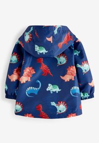 Imperméable avec imprimé de dinosaures bleus, doté d'une capuche, de poignets élastiques et de couleurs vives comme le rouge, le vert et le rose. Matière lisse et résistante à l'eau.