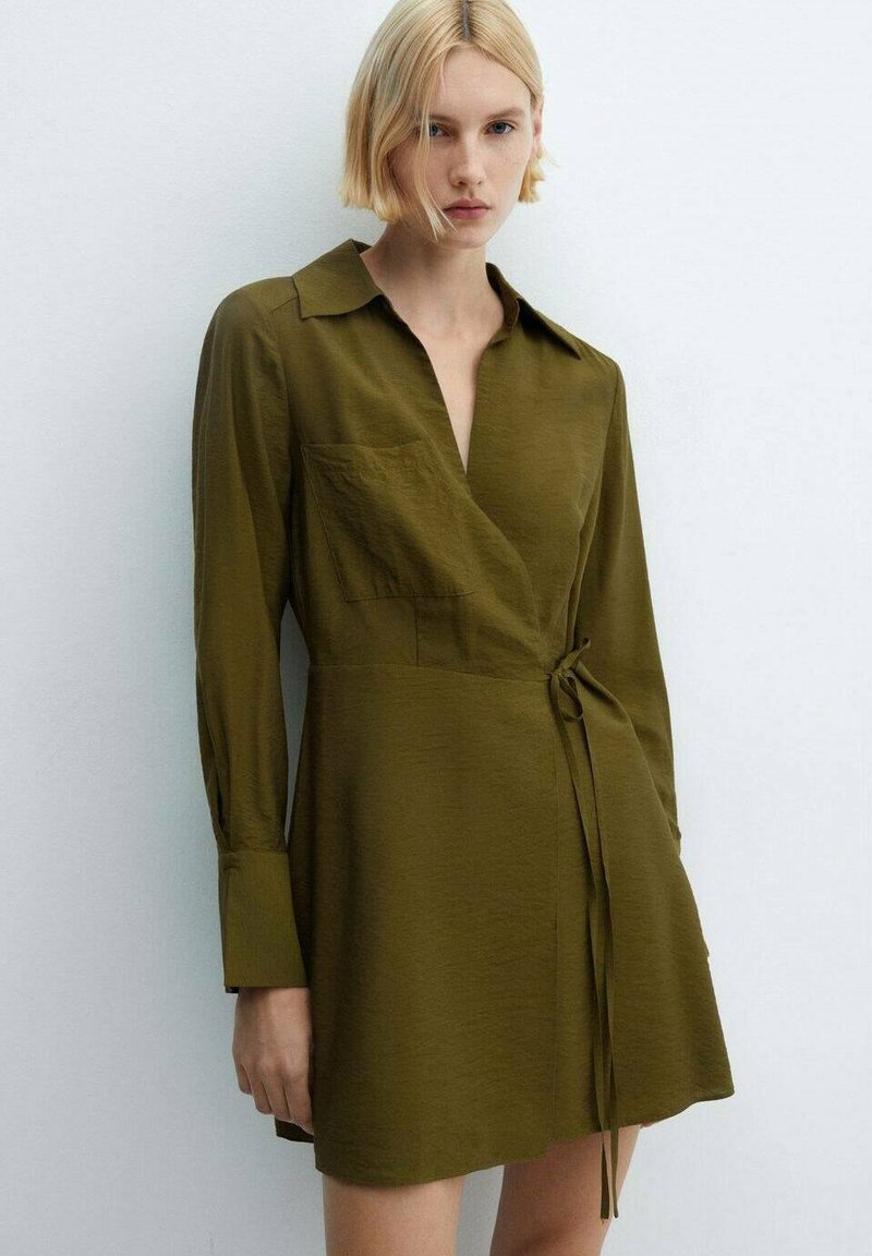 Olive green wrap dress with a collar, long sleeves, and a tie at the waist. Features a front pocket and a smooth, lightweight texture.