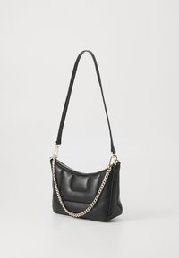 Sac à main en cuir noir avec une surface texturée, doté d'une bandoulière en chaîne et en tissu, et d'une fermeture éclair inclinée.