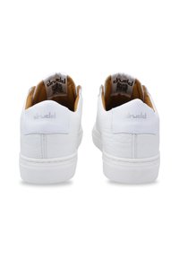 White sneakers made of textured leather with a flat sole, featuring tan interiors and subtle branding on the heel and tongue.