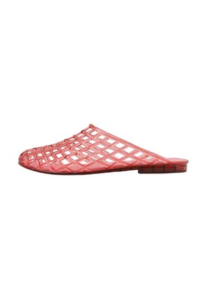 Zapato translúcido rojo tipo slip-on con patrón de rejilla abierta y suela plana, diseñado para uso informal.