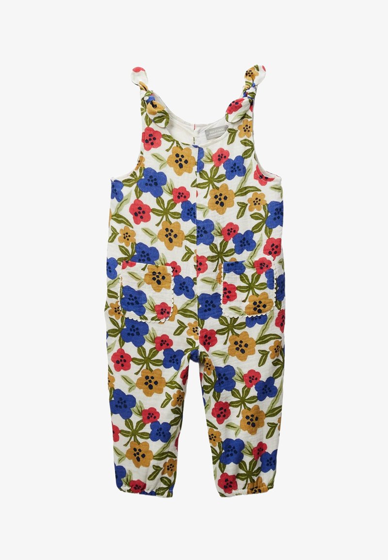 Salopette sans manches pour enfants avec des bretelles nouées, des chevilles élastiques, des poches avant et un motif floral rouge, bleu et jaune sur un tissu blanc.