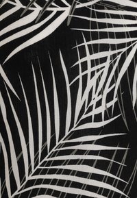 Tela negra con patrones de hojas de palmera en blanco y gris, con variaciones en el grosor de las líneas que crean una apariencia texturizada.