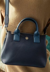 Navy leather handbag with two top handles, a detachable strap, and a textured finish. Features gold-tone hardware and a logo accent.