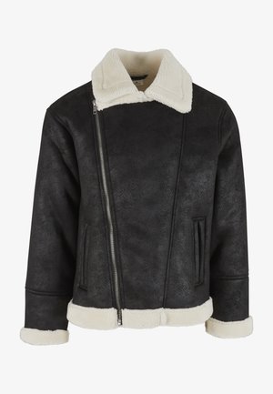 Black faux leather jacket with white shearling collar, cuffs, and hem, featuring an asymmetrical silver zipper and side pockets.