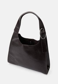 Brown leather shoulder bag with a curved handle, snap closure, and silver ring accent. Smooth texture, minimalist design, and rectangular shape.
