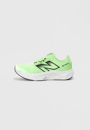 Neon green New Balance running shoe with black logo, white thick sole labeled FuelCell, and Propel branding on heel, side view.