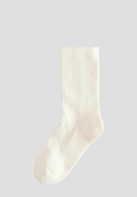 Single white ribbed crew sock laid flat against a plain light gray background.