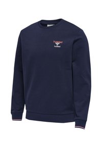 Granatowa bluza z długim rękawem z prążkowanymi ściągaczami z czerwono-białymi paskami oraz małym czerwono-białym logo Hummel na piersi.