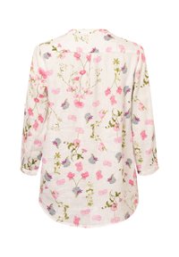 Blumen Langarmhemd aus cremefarbenem Stoff mit pinken und blauen Blumenmustern. Verfügt über einen abgerundeten Saum und aufrollbare Ärmelbündchen.