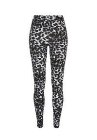 Leggings cu imprimeu de leopard alb-negru, cu talie înaltă, realizate dintr-un material elastic și neted care se conturează pe picioare.