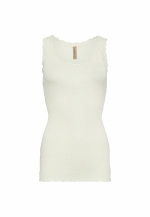 Vit ribbad linne med scalloped spetstrim vid halsringningen och armhålorna. Fitted form med en ren, zipad bottenkant.