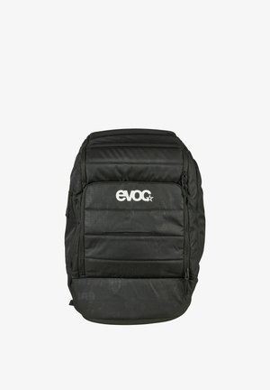 Schwarzer gepolsterter Rucksack mit vorderer Reißverschlusstasche und weißem "evoc"-Logo, das mittig auf der Tasche platziert ist, vor weißem Hintergrund präsentiert.